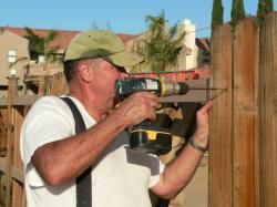 Man Installing Wooden Fence